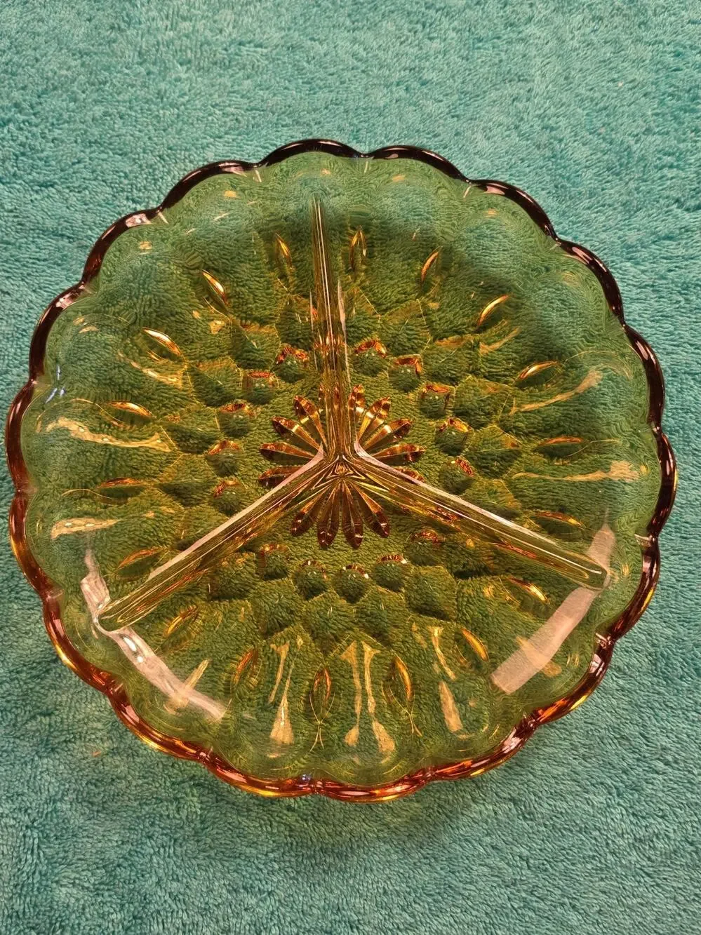 Vintage amber glass divided relish dish with pressed floral pattern.